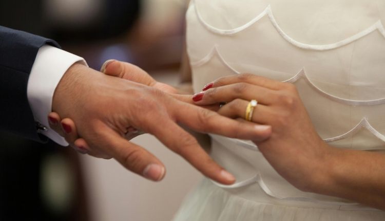 Couple wearing wedding rings